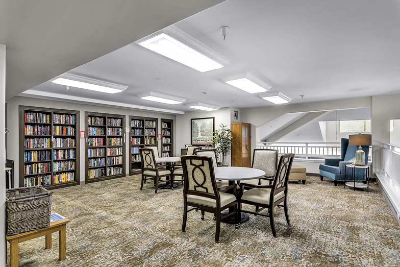 The library at Chesterfield Heights with shelves of books and comfortable seating